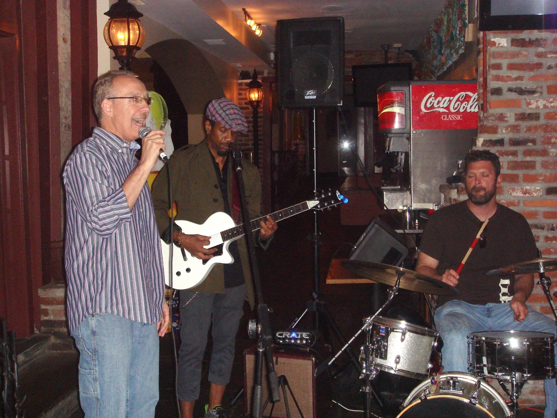Rick Gabe singing with his band at a live venue